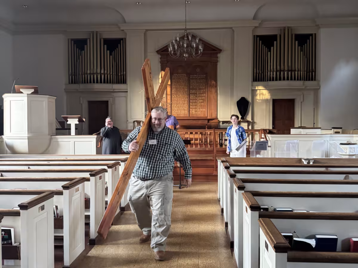 Parishioner carrying a large wooden cross